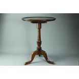 A mahogany circular occasional table