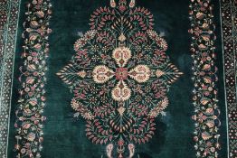 A Stunning Persian emerald green silk Qum carpet