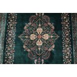 A Stunning Persian emerald green silk Qum carpet