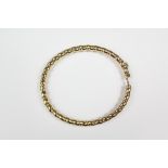 A 9ct yellow gold bangle