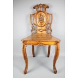 An Antique Walnut Heraldic Hall Chair