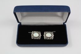 A Pair of Silver and Opal Cufflinks