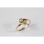 A Yellow Gold Diamond Cross Over Ring