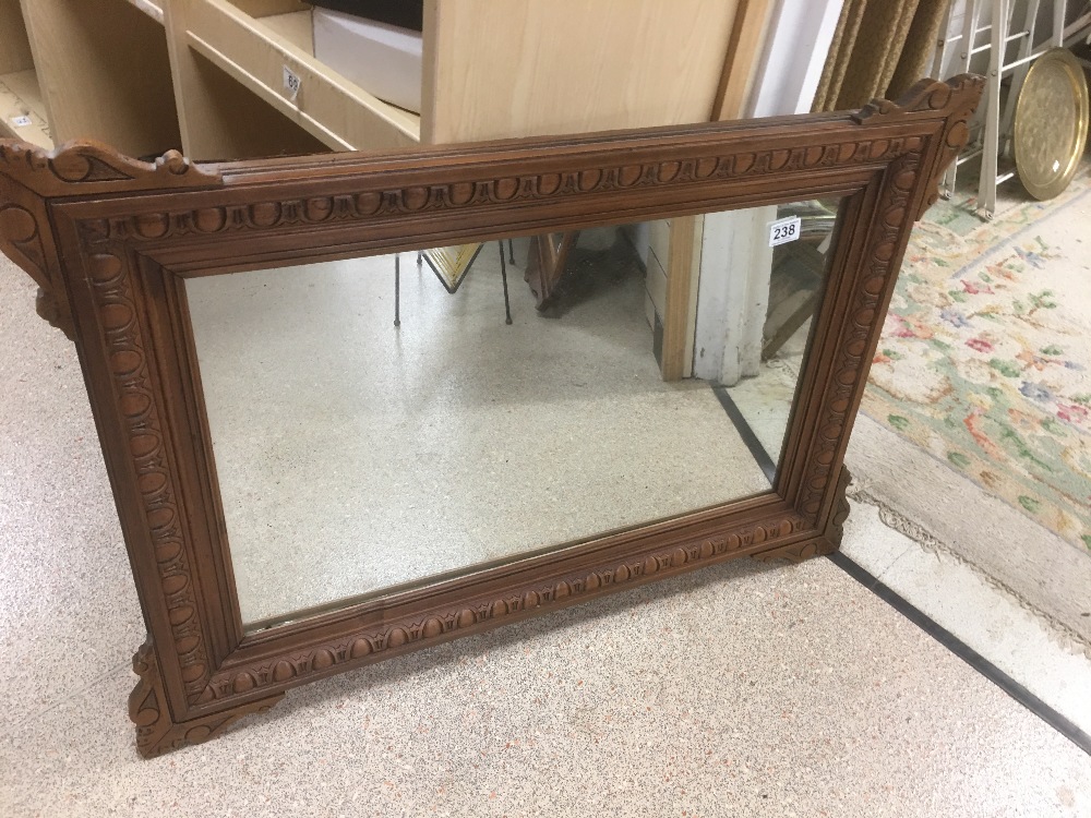 A FRENCH OAK FRAMED MIRROR 93 X 65 CM