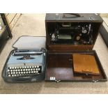 A CASED SINGER SEWING MACHINE WITH A VINTAGE BROTHER DE LUXE TYPEWRITER