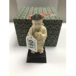 A 1920S CARVED IVORY FIGURE OF A GIRL HOLDING A PEACH, RAISED UPON WOODEN BASE, 13CM HIGH