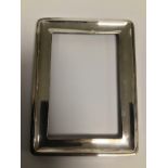 TWO SILVER MOUNTED PHOTO FRAMES, THE LARGEST OF WHICH HALLMARKED BIRMINGHAM 1929 BY HENRY