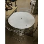 A WHITE METAL FOLDING ROUND TABLE WITH A PAIR OF WHITE METAL FOLDING CHAIRS 77 CMS DIAMETER
