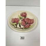 A MODERN WALTER MOORCROFT 'PINK MAGNOLIA' PATTERN ON IVORY GROUND, SIGNED WM, 26CM DIAMETER