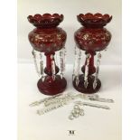 A PAIR OF VICTORIAN CRANBERRY GLASS LUSTRES WITH HANGING GLASS DROPLETS, THE TOP HALF WITH HAND