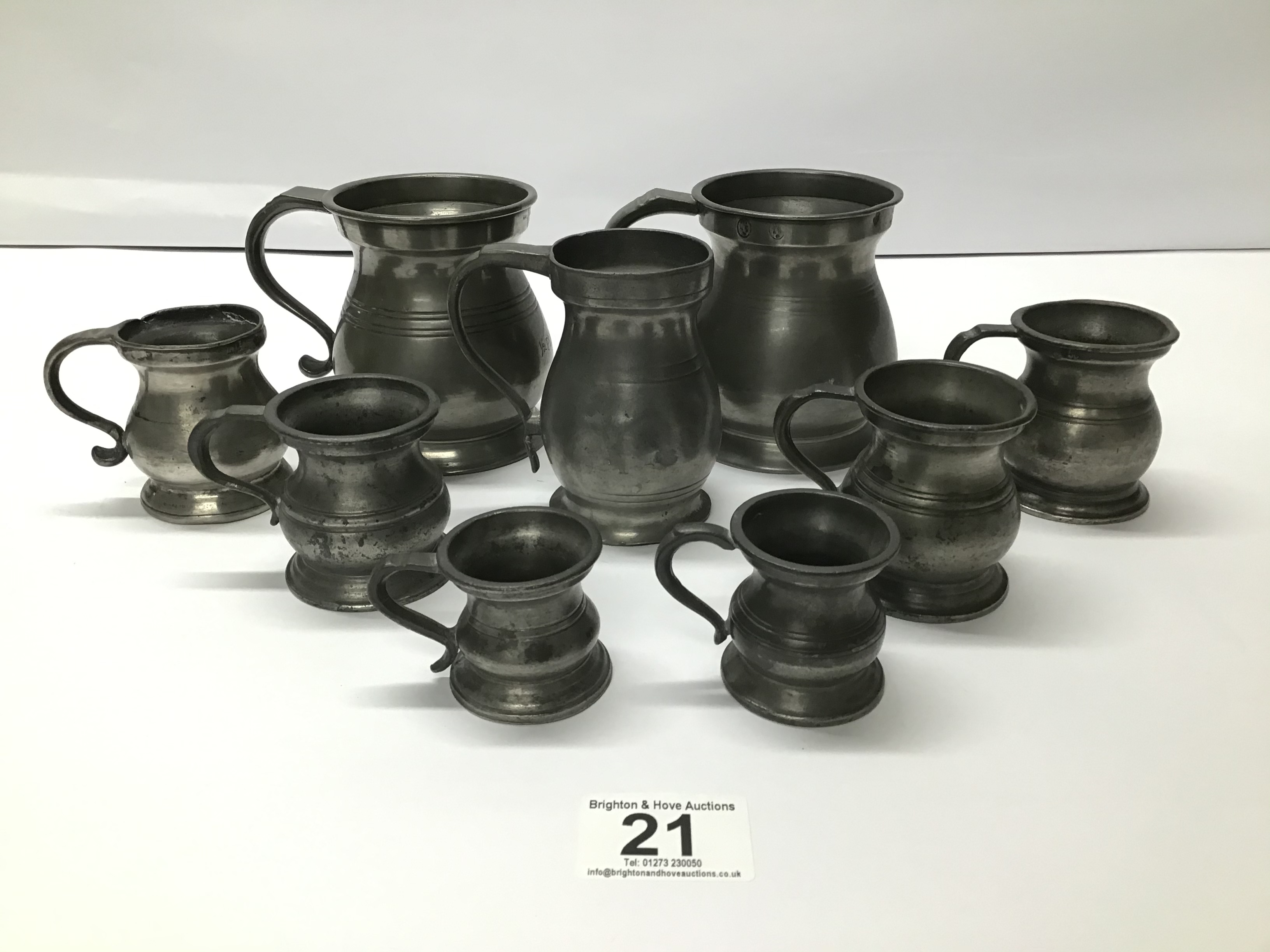 A GRADUATED SET OF PEWTER JUGS