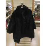 A BLACK LADIES ASTRAKHAN COAT IN BLACK WITH FUR COLLAR