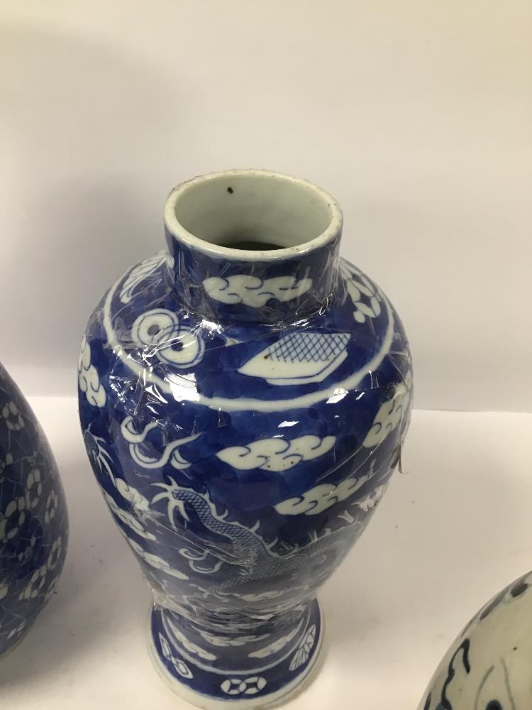 FOUR BLUE AND WHITE CHINESE PORCELAIN VASES, TWO OF WHICH DEPICTING A DRAGON CHASING THE FLAMING - Image 2 of 5