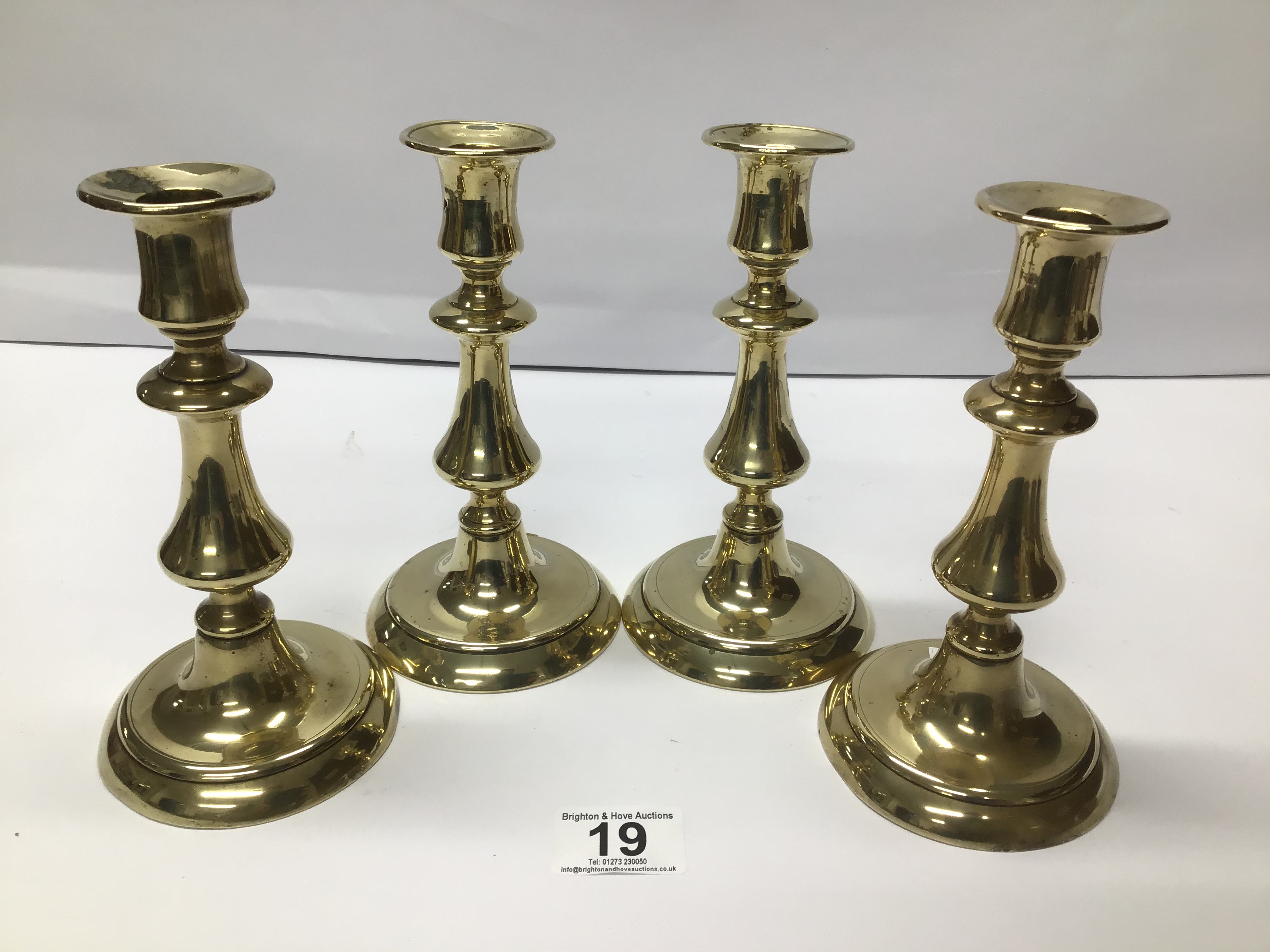 SET OF FOUR EARLY 19TH CENTURY BRASS BALUSTER CANDLESTICKS 18 CMS