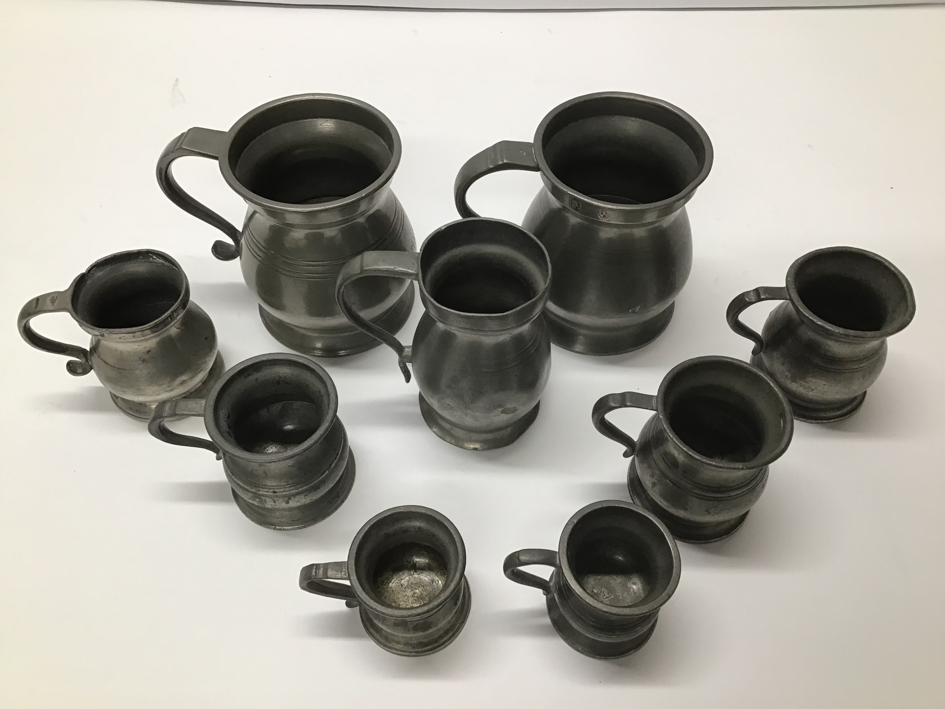 A GRADUATED SET OF PEWTER JUGS - Image 2 of 3