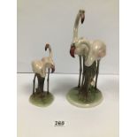 AN AUSTRIAN KERAMOS CERAMIC FIGURE GROUP OF TWO PINK FLAMINGO'S TOGETHER WITH A SMALLER PAIR,