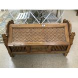 AN ORNATE WOODEN BLANKET BOX