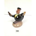 A BESWICK WARE 1517 FIGURE OF A RUNNING MAN HOLDING A BOTTLE AND BRIEFCASE, 21CM HIGH