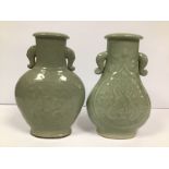 TWO CHINESE CELADON GLAZED TWIN HANDLED VASES, LARGEST 29.5CM HIGH, BOTH WITH HOLES TO THEIR BASES