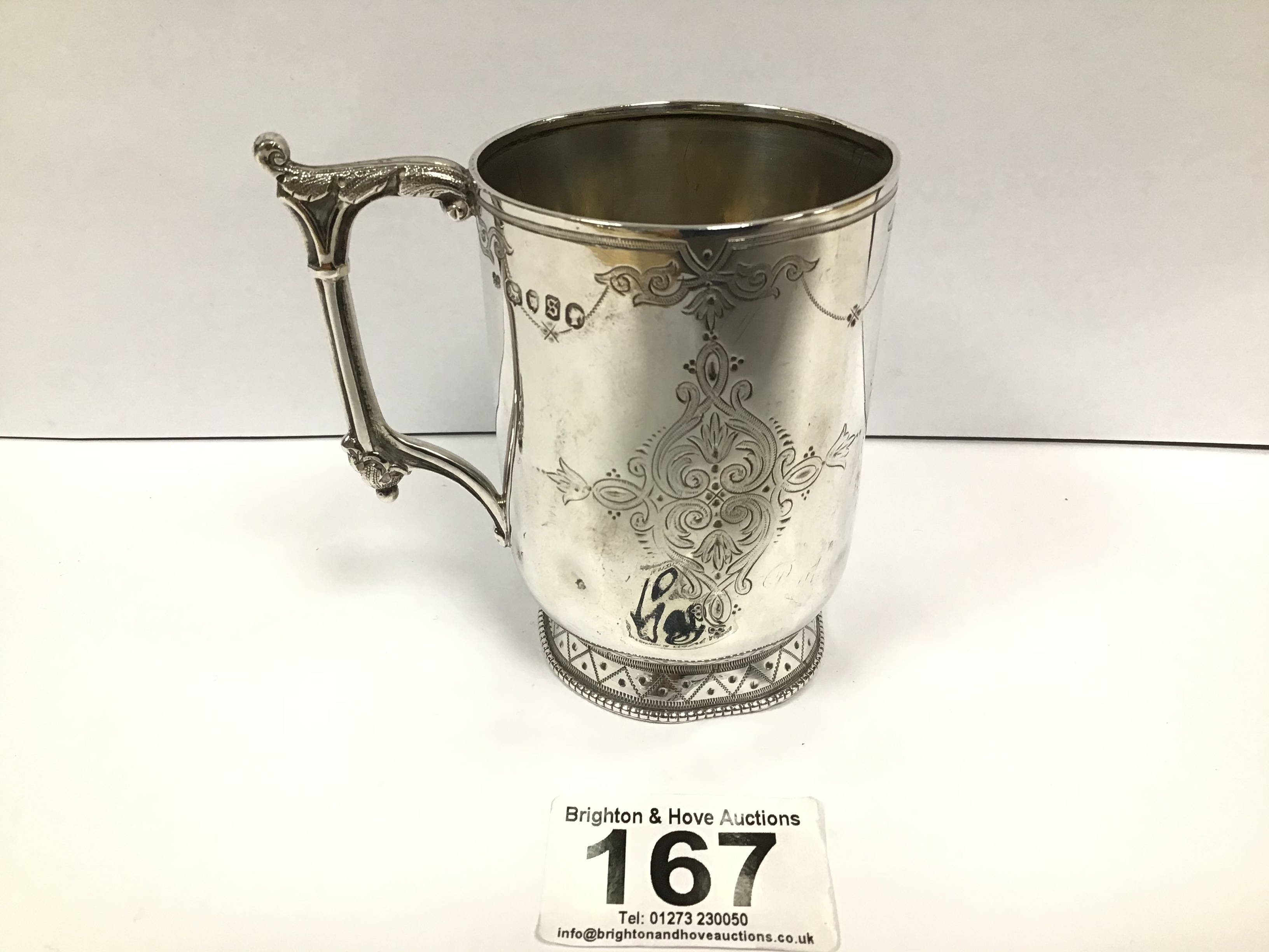 A VICTORIAN SILVER CHRISTENING MUG WITH EMBOSSED AND ENGRAVED DECORATION THROUGHOUT, HALLMARKED