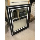 A LARGE FRAMED MIRROR 95 X 75 CMS