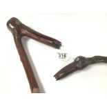 TWO WOODEN CARVED WALKING STICKS BOTH CARVED BIRDS WITH GLASS EYES