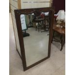 A MAHOGANY FRAMED MIRROR 132 X 80 CMS