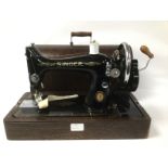 A VINTAGE CASED HAND CRANK SINGER SEWING MACHINE