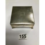 A SQUARE SILVER ENGINE TURNED CIGARETTE BOX UPON TURNED SUPPORTS, HALLMARKED BIRMINGHAM 1937, MAKERS