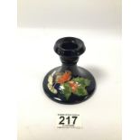 A MOORCROFT POTTERY CANDLESTICK WITH ROBIN AMONGST HOLLY DESIGN, 9CM HIGH