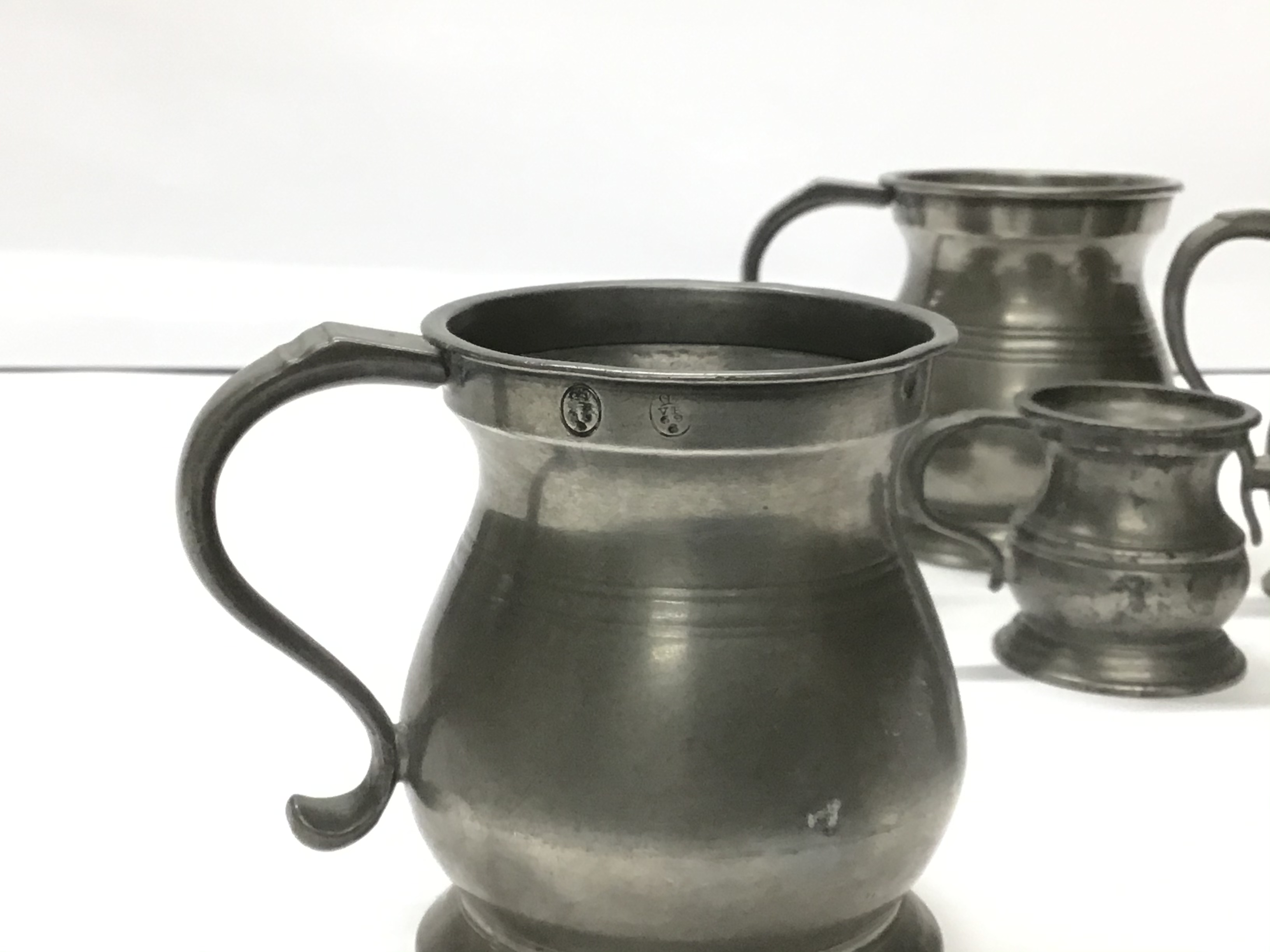 A GRADUATED SET OF PEWTER JUGS - Image 3 of 3