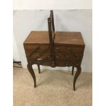 A VINTAGE WOODEN CANTILEVER SEWING BOX WITH VINTAGE SEWING ITEMS