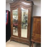 A FRENCH WALNUT ARMOIRE WITH TWO MIRRORED DOORS
