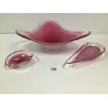 THREE PINK ART GLASS ITEMS, INCLUDING A LARGE TRIANGULAR DISH, POSSIBLY FLYGORS, A TEARDROP SHAPED