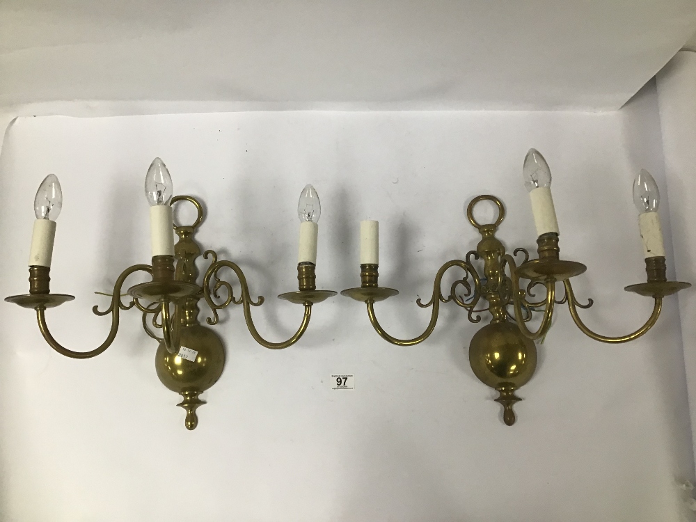 A PAIR OF VINTAGE THREE BRANCH ARM BRASS WALL LIGHTS