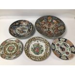 FIVE ORIENTAL PORCELAIN PLATES/CHARGES LARGEST 35 CMS DIAMETER (ALL A/F WITH EARLY REPAIRS)
