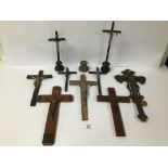 A COLLECTION OF RELIGIOUS CRUCIFIXES, MOST CARVED WOODEN WITH APPLIED METAL DETAILING, LARGEST