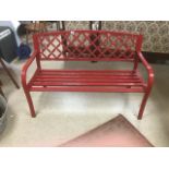 A RED METAL GARDEN BENCH 128 CMS