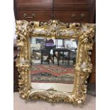 A LARGE GILDED MERCURY VICTORIAN MIRROR, OF WOOD AND PLASTER EXTERNAL102 X 112CMS, INTERNAL 57 X