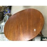 A MID-CENTURY TEAK EXTENDING DINING TABLE