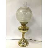 AN EARLY 20TH CENTURY BRASS OIL LAMP WITH ORIGINAL GLASS SHADE AND FUNNEL, 54CM HIGH (PREVIOUSLY