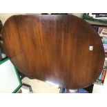 A MAHOGANY DROPLEAF TABLE WITH BRASS PAW FEET