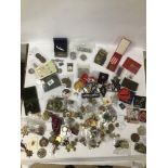 A BOX OF MIXED BADGES, MEDALS, COINS AND BUCKLES ETC