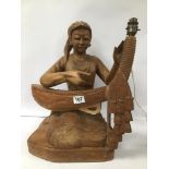 A LARGE CARVED WOODEN FIGURAL TABLE LAMP IN THE FORM OF A SEATED LADY, 46CM HIGH