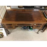 A FIVE DRAWER INLAID POLISHED DESK ON CABRIO LEGS