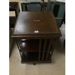 A MAHOGANY REVOLVING WOODEN BOOKCASE WITH MUSICAL INLAID PICTURE