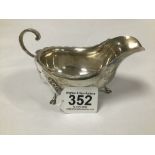 A GEORGE V SILVER SAUCE BOAT RAISED UPON THREE HOOF FEET, HALLMARKED SHEFFIELD 1916 BY HARRISON