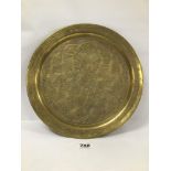 A MIDDLE EASTERN BRONZE AND COPPER CHARGER WITH HIGHLY ENGRAVED AND EMBOSSED DECORATION WITH