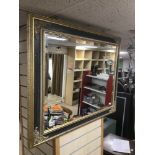 A BEVELLED GILDED MIRROR