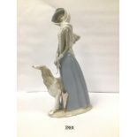 A LARGE LLADRO FIGURE GROUP DEPICTING A GIRL HOLDING A PARASOL STANDING BY AN AFGHAN HOUND, 39CM